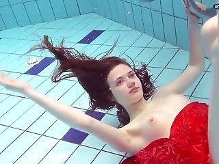 Crimson Clothed Teenager Swimming With Her Eyes Opened